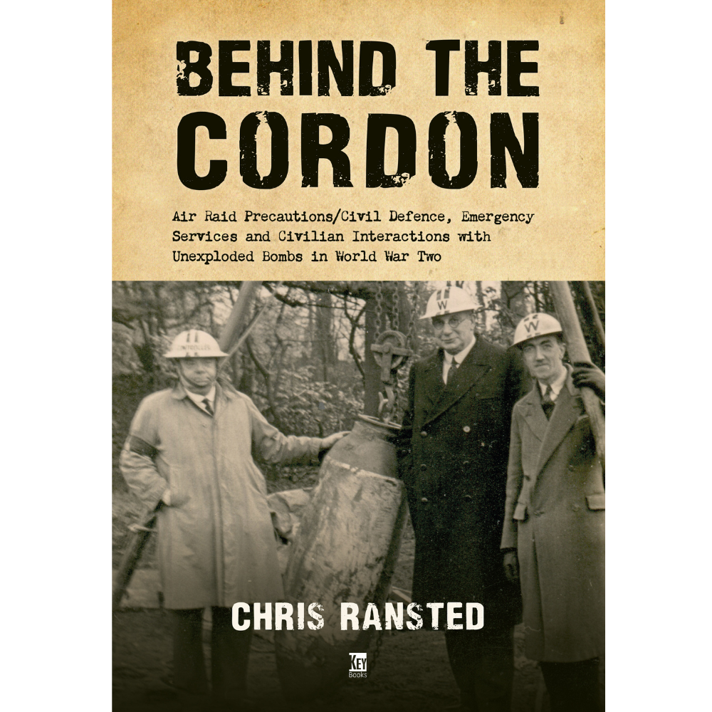 Book cover of 'Behind The Cordon' featuring black and white photograph of people in vintage clothing, possibly from the World War Two era, standing beside a cordon tape with the title and author name displayed.